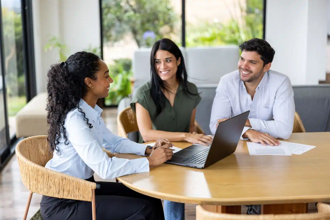 A business meeting between three professionals